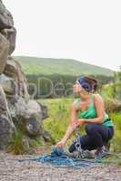 Pretty rock climber looking up at her challenge