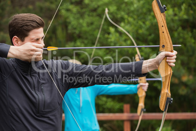 Handsome man practicing archery