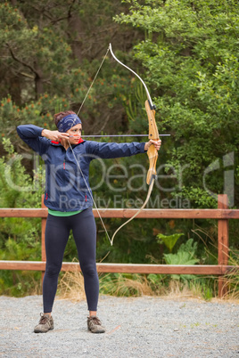 Brunette practicing archery