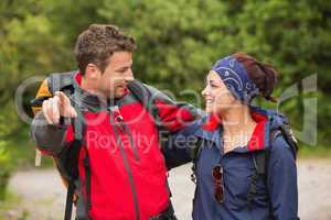 Smiling couple going on a hike together looking at each other