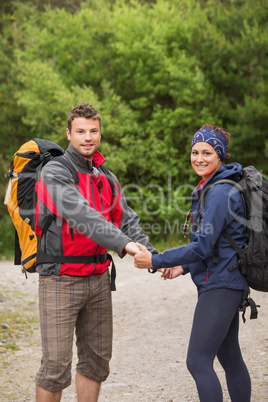 Loving couple going on a hike together holding hands