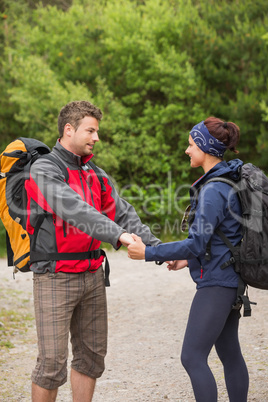 Cute couple going on a hike together holding hands