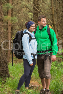 Smiling couple standing in a forest