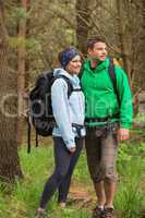 Smiling couple standing in a forest