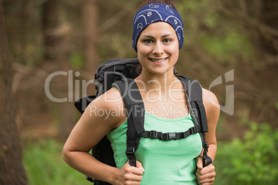 Smiling woman standing in a forest