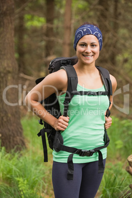 Pretty woman standing in a forest on a hike