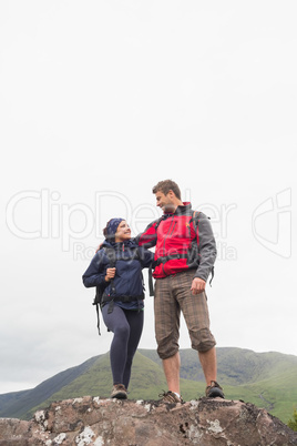 Couple standing on a rock embracing