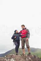 Couple standing on a rock embracing