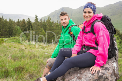 Couple sitting on a rock resting during hike