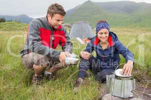 Couple cooking outside on camping trip
