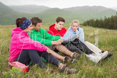 Friends sitting down looking at map