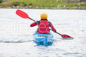 Woman rowing in a kayak