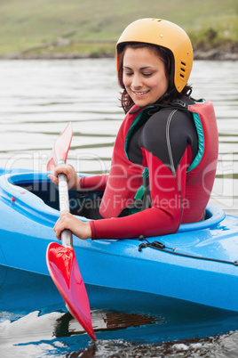Fit woman rowing on lake
