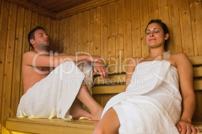 Happy couple relaxing in a sauna