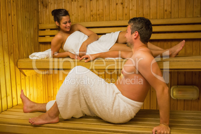 Calm couple relaxing in a sauna and chatting