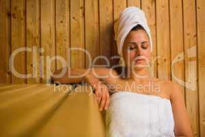 Calm woman relaxing in a sauna