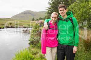 Athletic couple in hooded jumpers on a hike