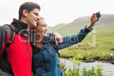 Athletic couple on a hike taking a selfie