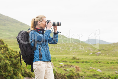 Blonde on a hike taking a photo