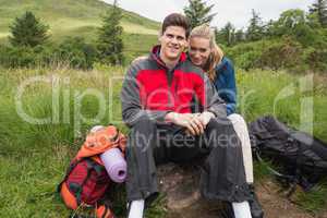 Happy couple taking a break on a hike