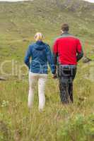 Couple holding hands and walking