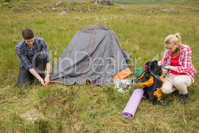 Couple pitching their tent