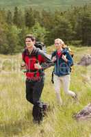 Happy couple setting out on a hike
