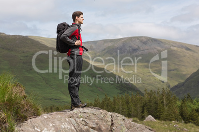 Man standing at hill top admiring the view