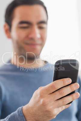 Happy casual man sending a text message