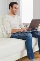 Smiling handsome man using his tablet computer