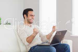 Successful handsome man looking at his laptop