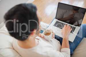 High angle view of young man using his laptop