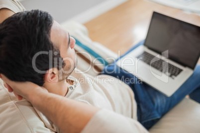 High angle view of relaxed young man using his laptop