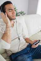 Pensive handsome man listening to music