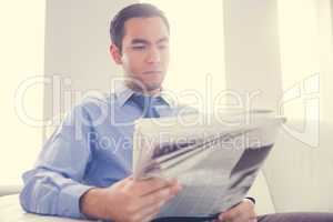 Handsome businessman reading newspaper