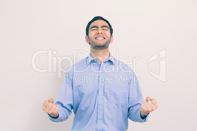 Victorious man standing clenching his fists