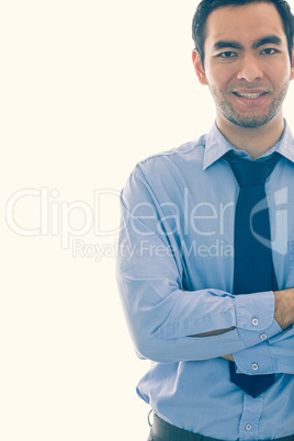 Smiling man looking at camera standing in front of a window