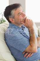 Thinking man sitting on sofa