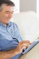 Smiling man using a tablet pc