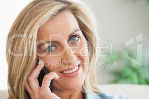 Smiling woman calling someome with her mobile phone