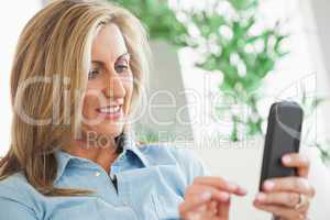Woman concentrated typing on her mobile phone