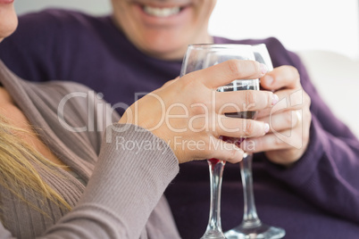 Smiling couple toasting with wine