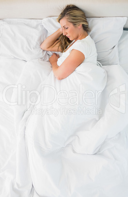 Sleeping woman lying on her bed