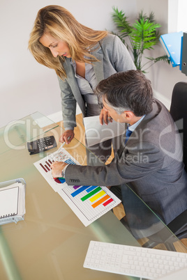 Two business people looking at documents in an office