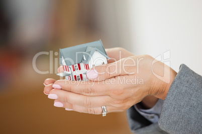 Woman holding a house in her hands