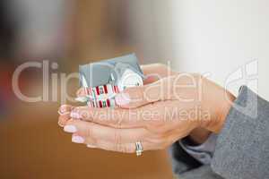 Woman holding a house in her hands