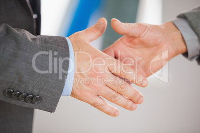 Two people going to shake their hands