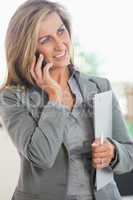 Smiling woman calling someone with her mobile phone