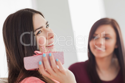 Smiling girl holding a present