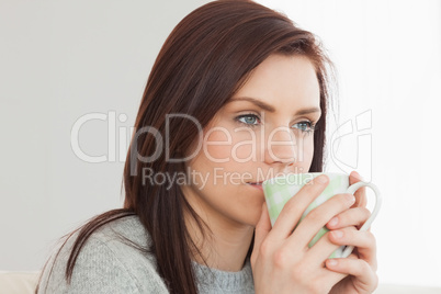 Thoughtful girl drinking a cup of coffee